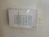 a picture of a white wall with a keypad on it