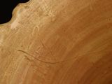 a close up of a wooden bowl with a black background