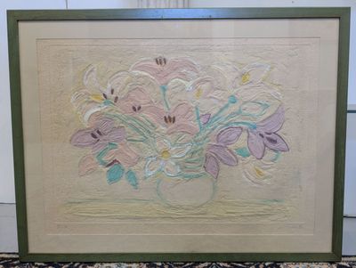 painting of a bouquet of flowers in a green frame on a rug