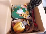 a box with a doll and other items inside of it