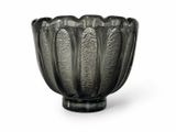 a black glass bowl that is sitting on a white surface