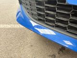 a close up of the front of a blue car