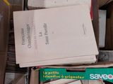 a box full of books sitting on a wooden floor