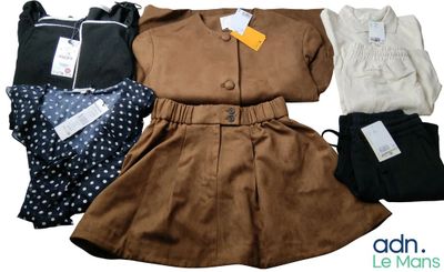 a group of clothing that includes a dress, jacket, and pants