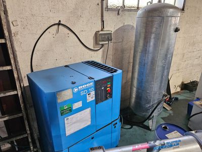 a blue machine that is sitting next to a blue tank