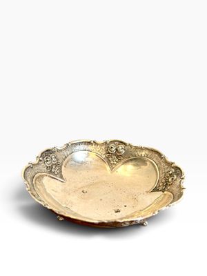 a gold plate with a flower design on it
