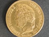 a close up of a gold coin on a black surface