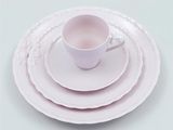 a white plate with a cup and saucer on it