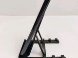 a black tablet on a stand on a white surface