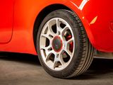 a close up of a red car parked in a garage