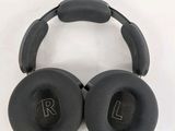 a pair of black headphones sitting on top of a white surface