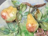 two pears on a plate with flowers on it