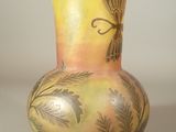 a yellow vase with a dragonfly design on it