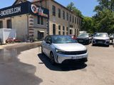 a white car parked in front of a building