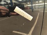 a person holding a parking ticket in a parking lot