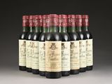 six bottles of wine are lined up in a row on a table