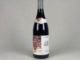 the bottle of wine is sitting on the table with a white background