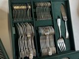 a green case with silverware in it on a table