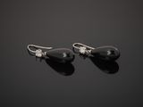 a pair of black onyxite and diamond earrings