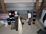 many different types of pipes on a pallet in a garage