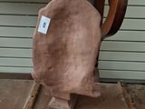 a piece of clay sitting on top of a wooden chair