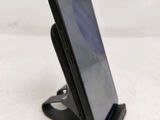 a cell phone that is on a stand on a table