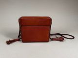 an image of a small brown bag with a tassel on it