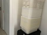 a stack of plastic containers sitting on top of a black box