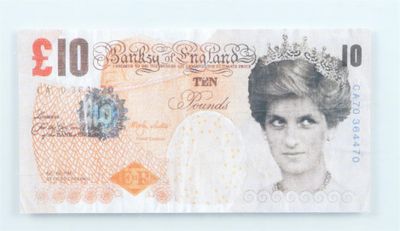 a picture of a british ten pound note on a white surface