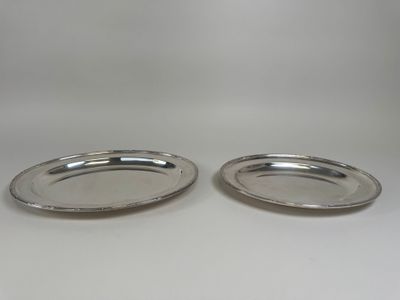 a pair of silver plated dishes on a white background