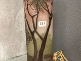a vase with a picture of a tree and a bird on it