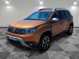 the orange dacia is parked on a checkered tile floor