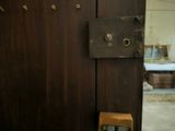 a wooden door with a lock on it in a room