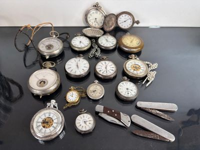 many different types of pocket watches sitting on a table