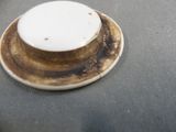 a brown and white plate with a white top on a table