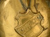 a gold helmet with an apple on top of it
