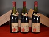 three bottles of wine are sitting on a table with a wooden box