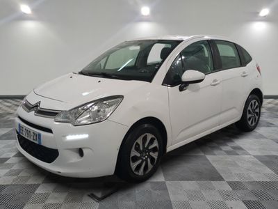 the white citrole is parked on a checkered tile floor