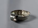 a silver bowl with a spoon in it on a table