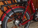 a red bicycle with a basket on the back of it