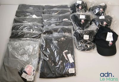 many bags of clothing and a hat on a table