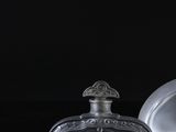 a bottle of perfume and a glass bottle on a table