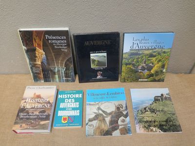 several books are sitting on a table in front of a wall