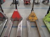 four forklifts sitting on the floor in a warehouse