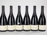 six bouteilles de vin sont alignées sur une table