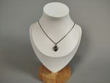 a necklace on a mannequin with a heart on it