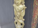 a black cabinet with a gold decoration on it