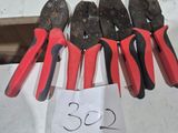 several pliers are lined up on a table with a price tag
