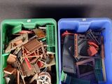 two plastic containers filled with assorted toys on a table