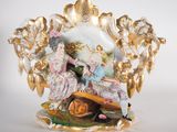 a figurine of two people sitting on a bench